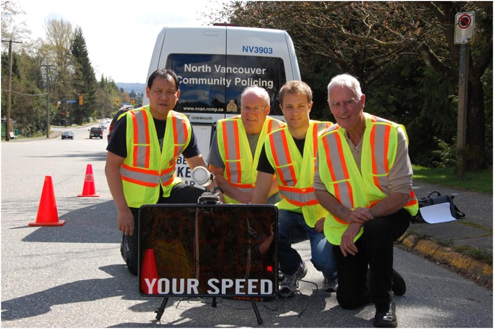 picture of 4 volunteers and speed reader board